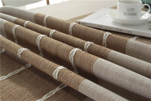 Detailed view of jacquard cotton linen tablecloth with fringe and white stitched patterns