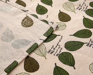 Detail of leaf pattern and neat double stitching on cotton-linen tablecloth fabric