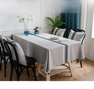 Detail of grey waterproof linen table runner with modern blue vertical stripe pattern