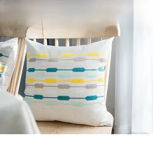 Close-up of geometric embroidery patterns on Nordic style linen decorative pillowcase