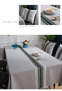 Detail of grey waterproof table runner with embroidered blue and green vertical stripes