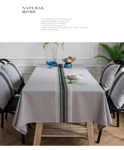 Close-up of modern gray cotton linen table runner with woven geometric embroidery textures