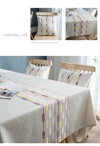 Detail of embroidered colorful vertical stripes on beige cotton linen table runner fabric