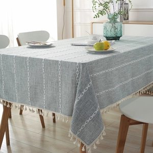 Light blue-grey jacquard tablecloth with white embroidery and elegant fringe edges