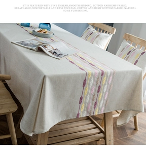 Close-up of cotton linen table runner with colorful embroidery and fine stitching