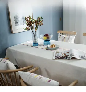 Detail of linen cotton table runner featuring colorful geometric embroidery and texture