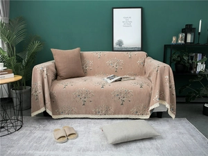 Close-up of thick chenille sofa cover with tree pattern and white lace edge detailing
