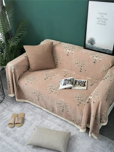 Detailed view of pink chenille sofa cover with tree patterns and white lace edges