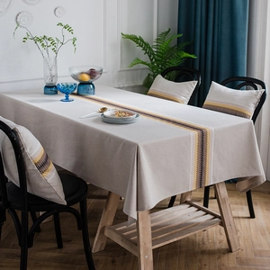 Modern linen textured grey tablecloth with geometric yellow stripes and matching pillows