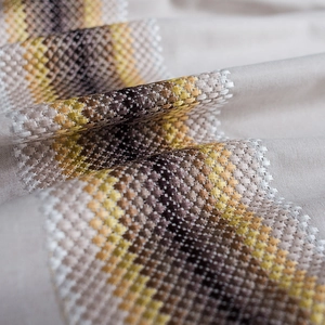 Modern wavy embroidered table runner with geometric linen texture in mustard and brown