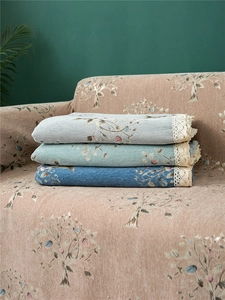 Close-up of thick chenille sofa cover with floral jacquard and lace embroidery details