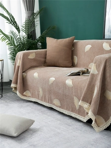 Detail of chenille sofa cover showing ginkgo leaf jacquard and white lace trim