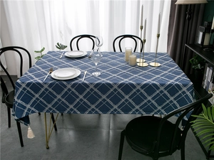Navy blue Nordic tablecloth with white diamond pattern and tassels in a modern dining setting