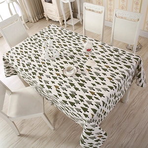 Detail of rectangular tablecloth featuring festive green and brown Christmas tree patterns