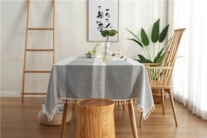 Close-up of striped cotton linen table runner featuring elegant white fringe tassels