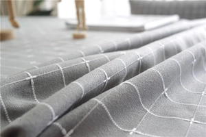 Close-up of grey plaid textured polyester fabric with white cross check pattern