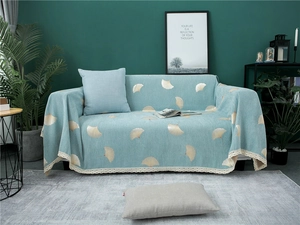 Detail of light blue chenille sofa cover featuring gold ginkgo leaves and lace trim