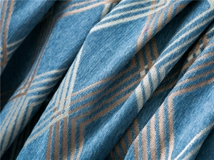 Detailed macro view of heavy chenille fabric featuring blue and beige geometric diamond patterns