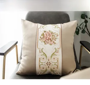 Close-up of luxury champagne gold pillow with rose embroidery on a modern chair