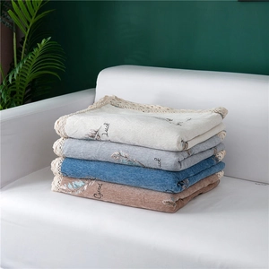 Detail of chenille sofa covers with lace edges, feather patterns and Good Luck text