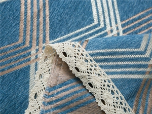 Close-up of chenille sofa cover showing geometric diamond pattern and beige lace trim