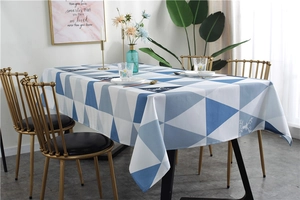Detail of Nordic waterproof tablecloth with blue geometric triangles and brand logo