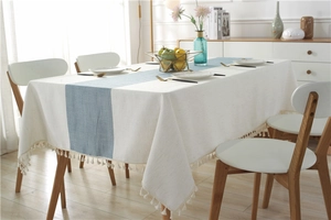 Detail of waterproof table runner with blue wave pattern and dense white fringe tassels