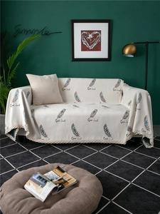 Detail of chenille sofa cover showing feather patterns, Good Luck print and lace trim