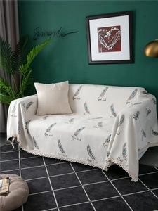 Detail of chenille sofa cover with feather patterns, Good Luck text and lace edges