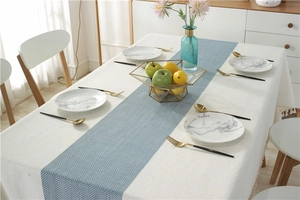 Macro detail of waterproof polyester linen table runner with chevron pattern and tassels