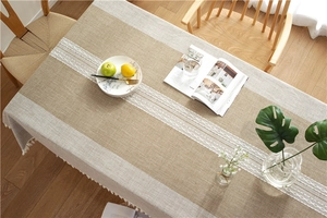 Detailed texture of cotton linen table runner with geometric embroidery and tassels