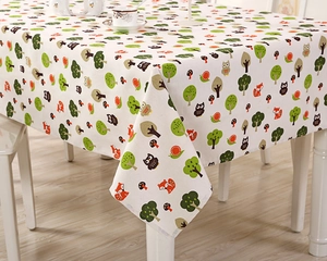 Detail of cartoon forest patterns with owls and foxes on a linen rectangular tablecloth