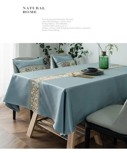Close-up of elegant floral embroidery on premium cotton and hemp light blue table runner