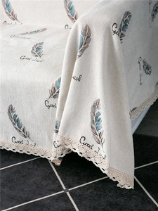 Close-up of thick chenille sofa cover with feather print and delicate beige lace edging