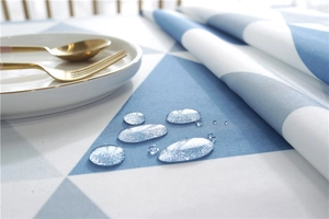 Close-up of waterproof polyester tablecloth with blue and white geometric triangle pattern