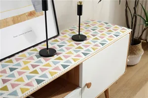 Close-up of modern chenille table runner with colorful geometric triangle patterns