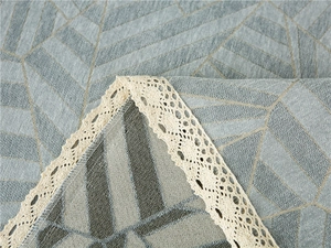 Macro shot of thick chenille sofa cover showing grey-blue leaf veins and lace edges