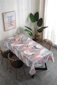 Detail of Nordic geometric table runner with pink gray patterns and cursive text
