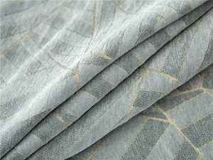 Close-up of thick blue chenille sofa cover fabric with gold geometric patterns