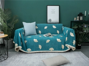 Detail of teal Chenille sofa cover featuring white ginkgo leaves and lace trim edge