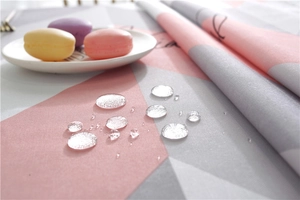 Close-up of waterproof Nordic table cloth showing geometric patterns and water droplets