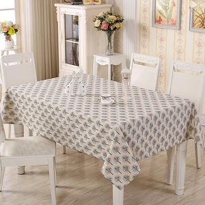 Detail of rectangular cream cotton tablecloth with black tree patterns and linen texture