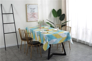 Detail shot of rectangular tablecloth featuring blue and yellow geometric triangle patterns