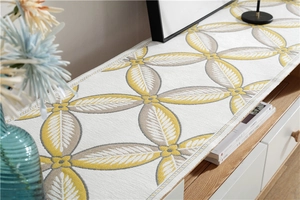 Close-up of chenille table runner with geometric leaf patterns and woven texture details