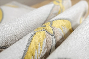 Detailed macro view of yellow and grey chenille jacquard fabric with floral patterns