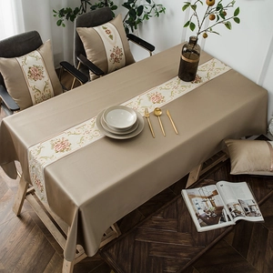Elegant beige rectangular tablecloth with floral embroidery and matching decorative pillows