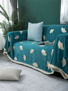 Detail of teal chenille sofa cover with yellow ginkgo leaves and lace trim