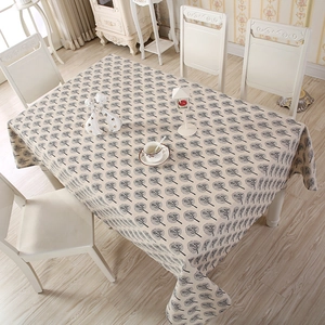 Close-up of Nordic style rectangle tablecloth with black tree patterns on linen fabric