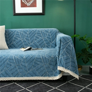 Close-up of thick chenille sofa cover with geometric patterns and delicate lace edge trim