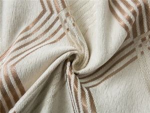 Close-up of thick chenille fabric featuring elegant bronze geometric line patterns